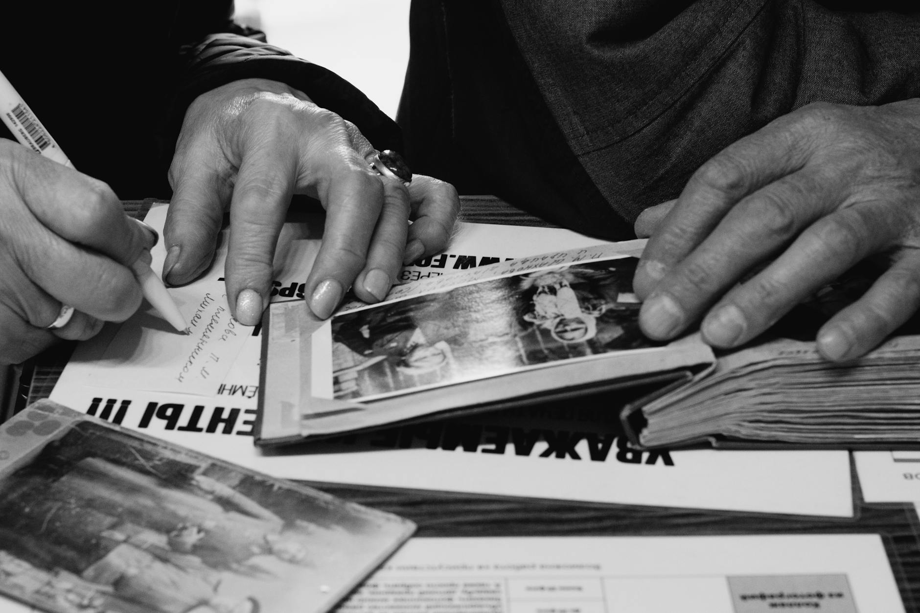close up of elderly man and woman looking at photographs